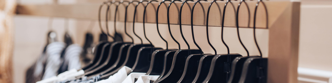 clothing rail in store with clothes on rail