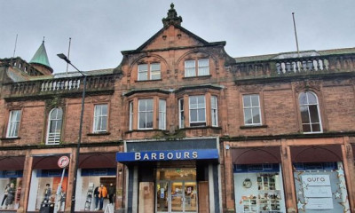 Historic stone building featuring a prominent sign that reads 