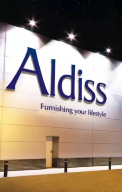 The exterior of a store with a large illuminated sign that reads 